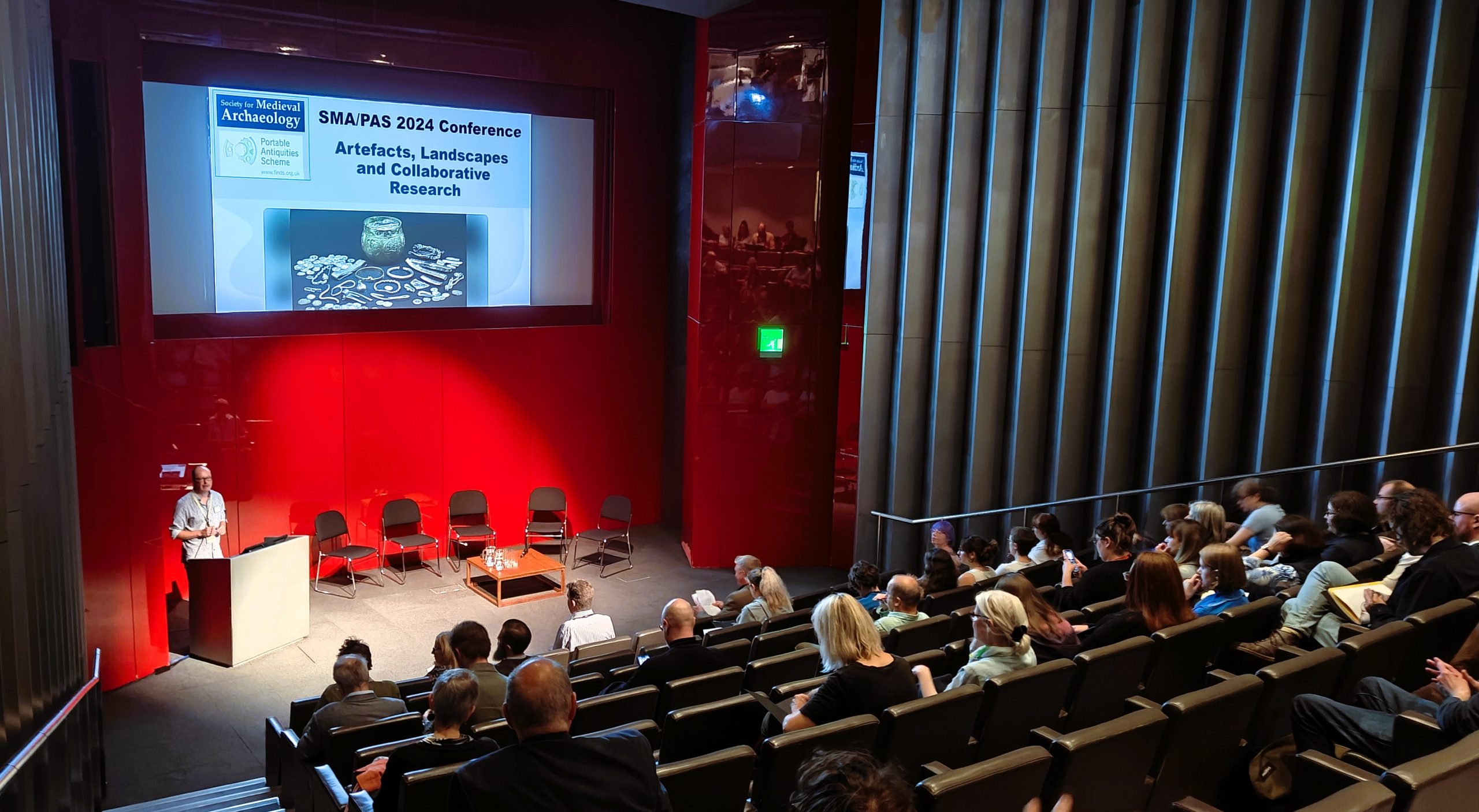 View of the lecture theatre at the British Museum, with audience seated listening to the speaker.